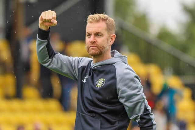 Harrogate Town manager Simon Weaver celebrates with the home fans following his side's dramatic 3-2 victory over Rochdale on August 7, 2021.