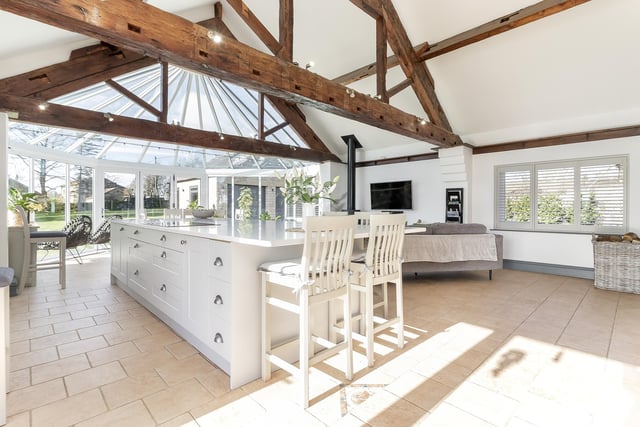 The brand new, open plan living and dining kitchen has open vaults to the ceiling and a cosy seating area with wood burning stove.