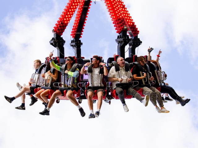 Festivalgoers enjoying the thrill of the fairground rides alongside the feel-good house music at the festival on The Stray in Harrogate