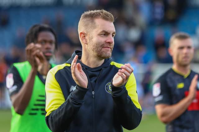 Harrogate Town manager Simon Weaver applauds the visiting supporters at Edgeley Park.