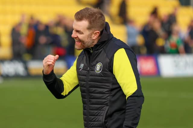 Harrogate Town manager Simon Weaver celebrates at the full-time whistle following his side's first home win of 2023.