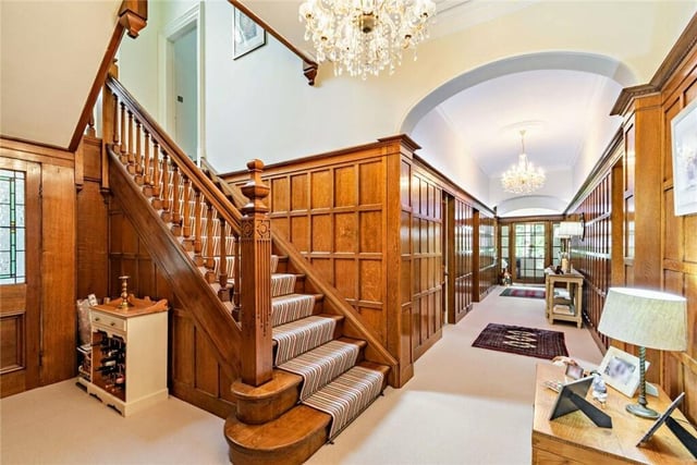The oak panelled hallway and staircase make a striking first impression.