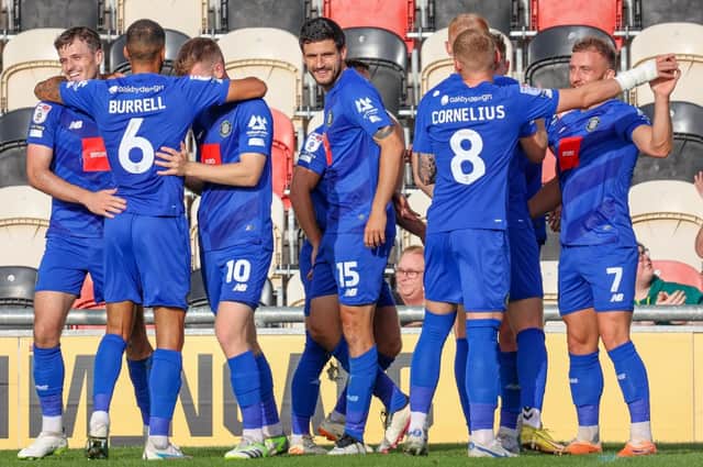 Harrogate Town players celebrate after going 2-0 up against Newport County on Saturday afternoon. Pictures: Matt Kirkham