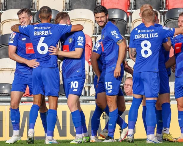 Harrogate Town players celebrate after going 2-0 up against Newport County on Saturday afternoon. Pictures: Matt Kirkham