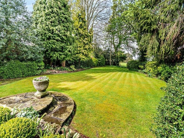 Established lawned gardens have borders filled with trees, shrubs and plants.