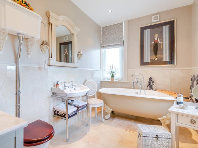 A stylish bathroom with freestanding, claw-foot bath tub.