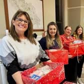 Bluebird Care Harrogate staff members, including Jessica Williams, second from left, with donations for Harrogate Women's Refuge.