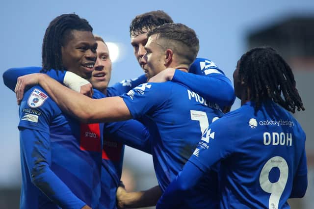 Harrogate Town players celebrate after taking the lead in New Year's Day's 2-2 draw at Morecambe. Pictures: Matt Kirkham