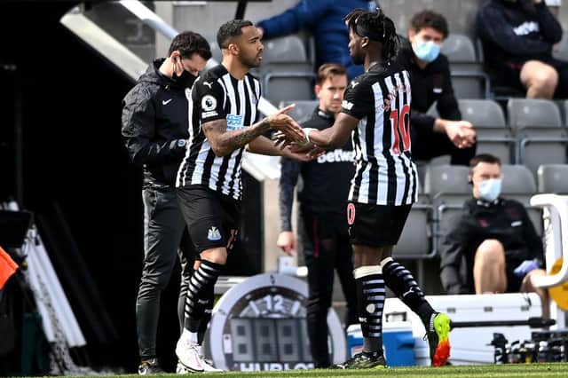 Callum Wilson of Newcastle United is substituted on for Allan Saint-Maximin  during the Premier League match between Newcastle United and West Ham United at St. James Park on April 17, 2021 in Newcastle upon Tyne, England.