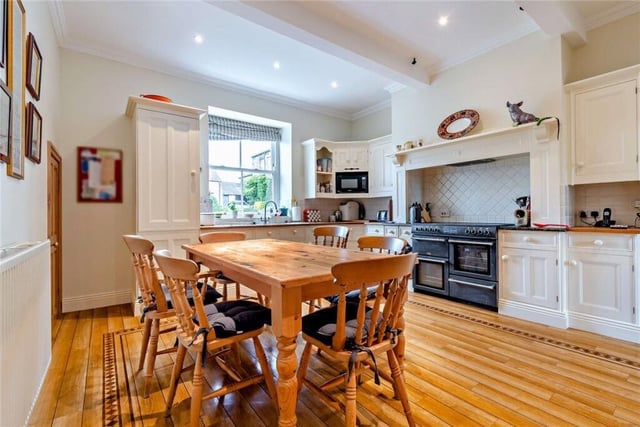 A country style dining kitchen with beamed ceiling.