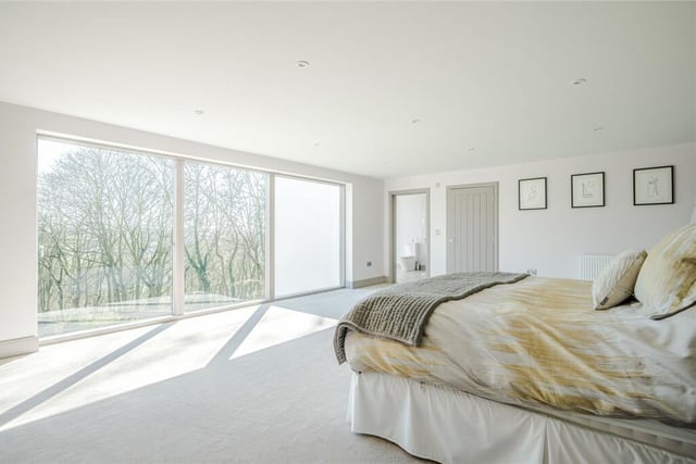 A bright and airy bedroom with a lovely landscape to look out on.