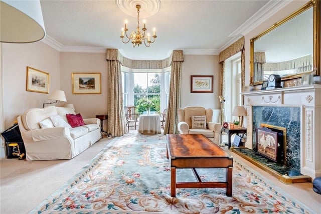 A spacious, bay fronted sitting room, with feature fireplace.