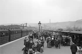 Crowds of day-trippers and holidaymakers arriving on a platform at Scarborough railway station in 1913.