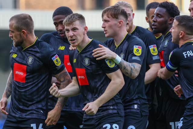 Matty Daly leads the Harrogate Town celebrations after netting their second-half equaliser against AFC Wimbledon on Saturday afternoon. Pictures: Matt Kirkham