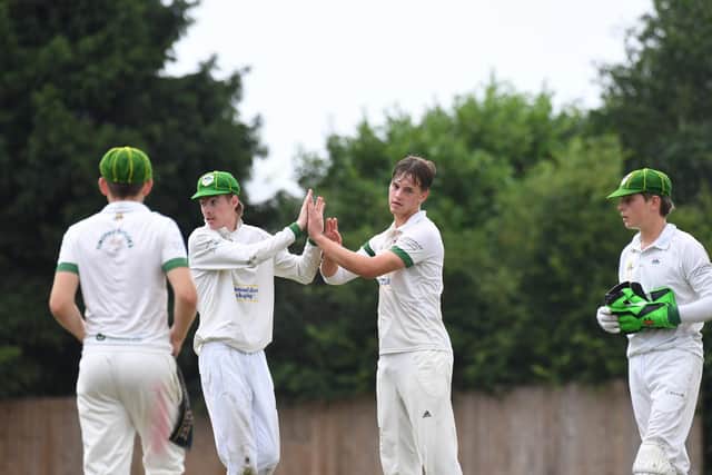 Ouseburn bowler Guy Jenkins, second from left, is congratulated after taking one of the four wickets he claimed against Arthington.