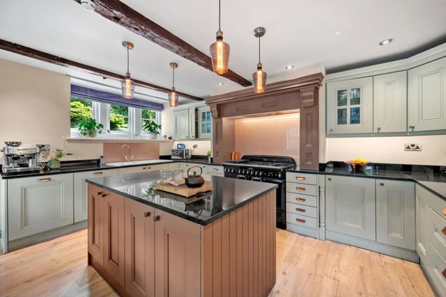The handcrafted kitchen with underfloor heating has a central island, and a Rangemaster cooker.