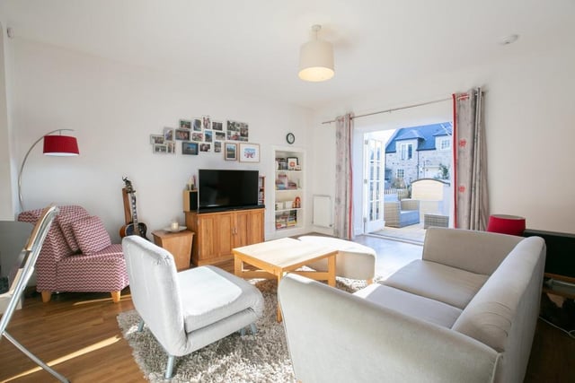 With French doors to the garden patio, the living room is filled with superb natural light.