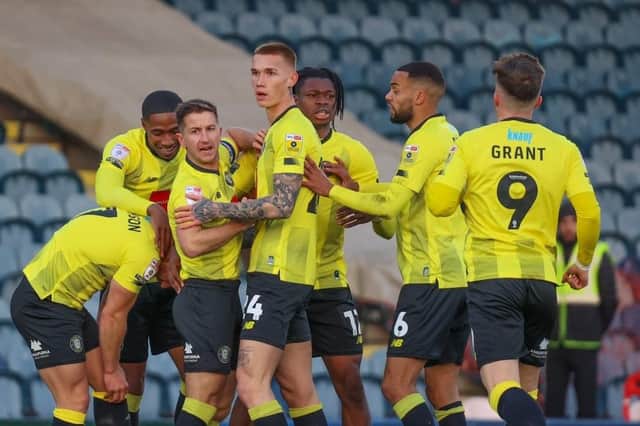 Harrogate Town's players celebrate George Thomson's first-half equaliser during Saturday's 4-1 League Two win at Rochdale. Pictures: Matt Kirkham