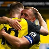 Harrogate Town captain George Thomson is congratulated by team-mate Matty Daly after netting what proved to be the winning goal during Tuesday night's League Two clash with Grimsby. Picture: Harrogate Town AFC