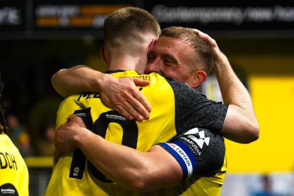 Harrogate Town captain George Thomson is congratulated by team-mate Matty Daly after netting what proved to be the winning goal during Tuesday night's League Two clash with Grimsby. Picture: Harrogate Town AFC