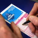 Filling out a lottery ticket.
