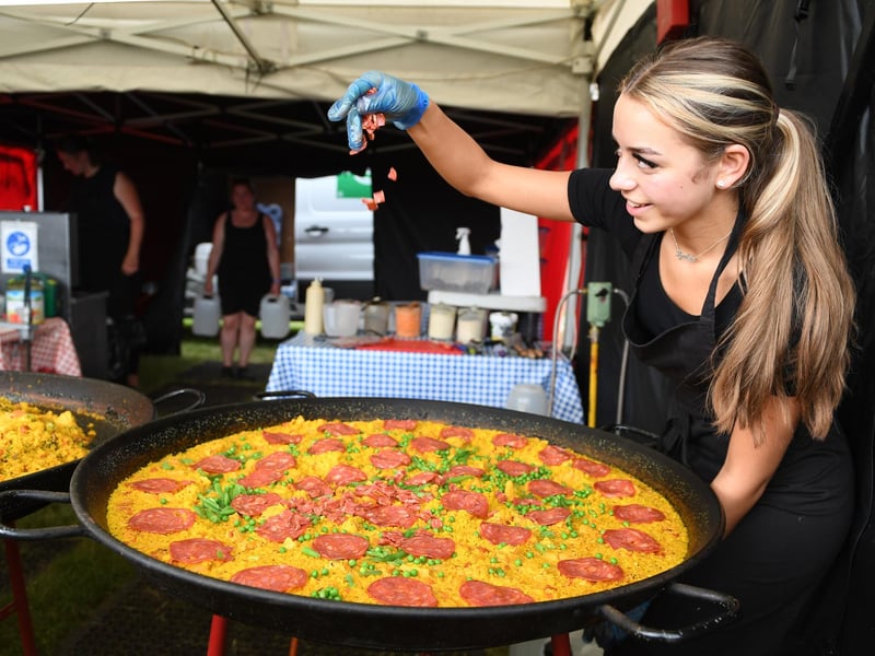 Lydia Margetts putting the finishing touches to a Chicken and Chorizo paella at the festival