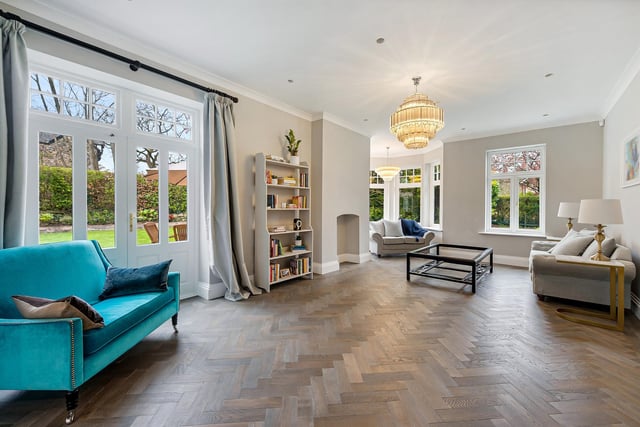The living room has a solid wood floor and a corner turret with bay window as a feature.
