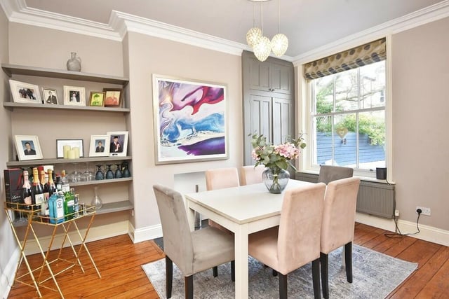 The bright and pleasant dining room with fitted shelving.