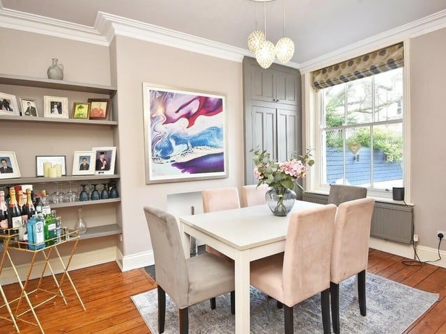 The bright and pleasant dining room with fitted shelving.