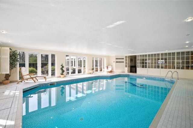 The indoor swimming pool links to the lounge room with bespoke bar, and has French doors out to the garden.