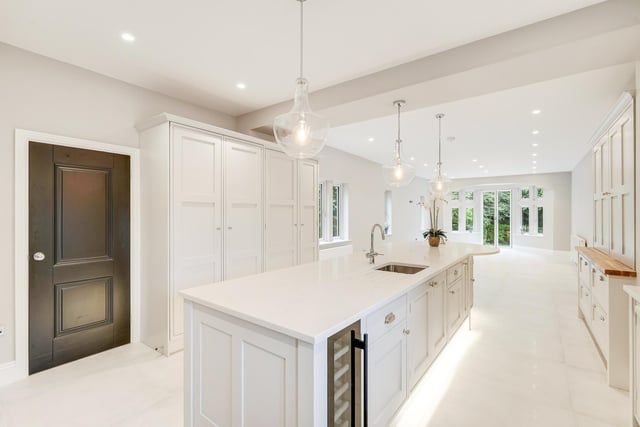 The sleek and high spec kitchen with French doors out to a patio area.