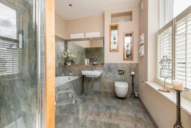 A stunning bathroom suite with both bath and walk-in shower.