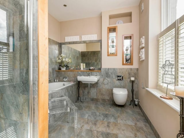 A stunning bathroom suite with both bath and walk-in shower.