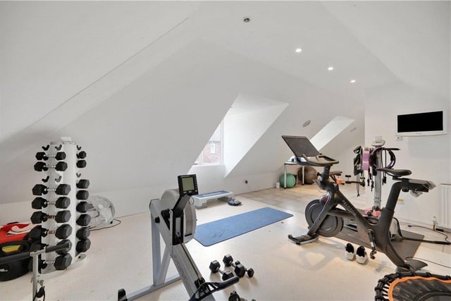 A gymnasium takes up part of the first floor space above the garage.