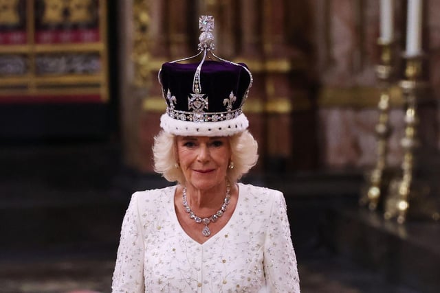 Queen Camilla stands after being crowned by Archbishop of Canterbury Justin Welby during her coronation ceremony in Westminster Abbey.