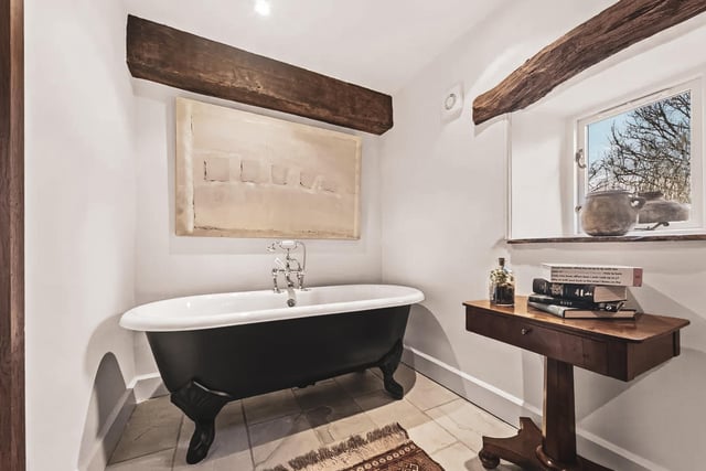 A second bathroom includes a roll top bath and exposed original oak beams.