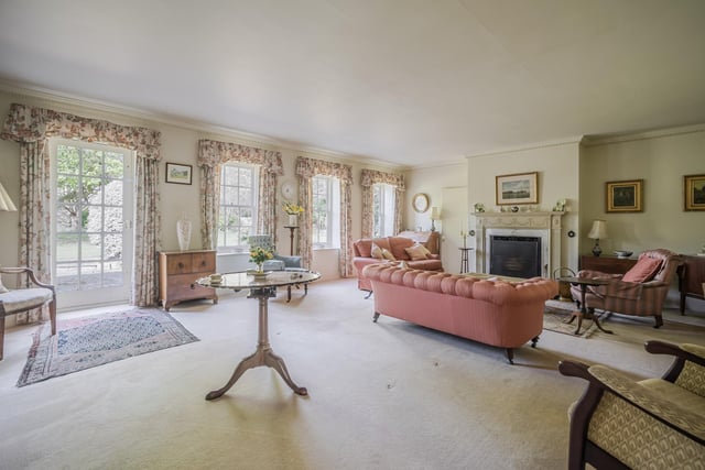 The elegant drawing room with views of the garden and paddock was once a milking shed.