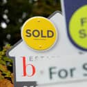 File photo of a sold and for sale signs.