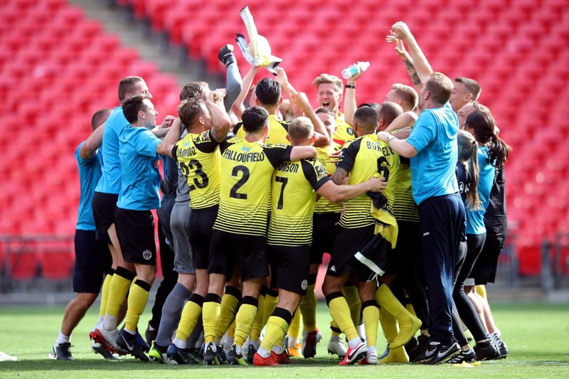 The players and staff celebrate after the final whistle at the Vanarama National League play-off final at Wembley