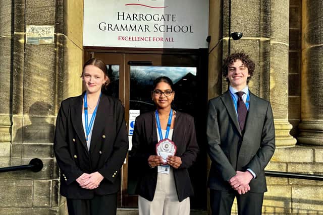 Left to right: Sophie, Swetha and Brando from Year 12 with their regional trophy.
