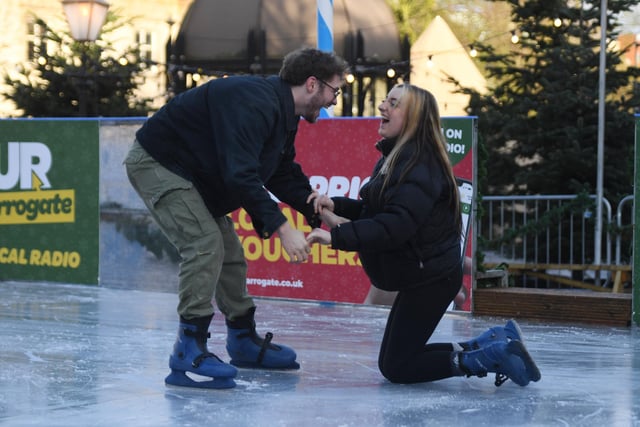 Saul Pratt picking up Chloe Hart after taking a tumble on the outdoor ice rink which can be found in the Crescent Gardens