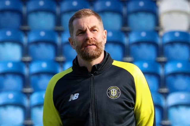 Simon Weaver watches his Harrogate Town players warm up ahead of Saturday's League Two clash at Colchester United. Pictures: Matt Kirkham