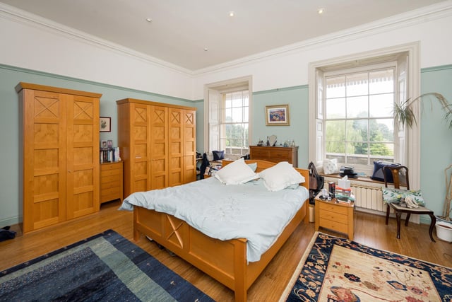 One of the double bedrooms with windows overlooking the extensive gardens.