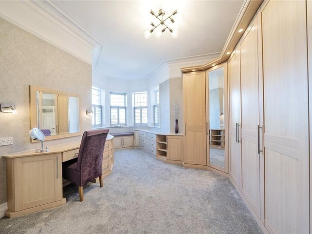 This dressing room is part of the main bedroom suite.