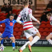 Harrogate Town midfielder Levi Sutton takes aim at the Doncaster Rovers goal during Tuesday night's 2-0 League Two success at the Eco-Power Stadium. Pictures: Matt Kirkham