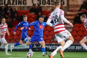 Harrogate Town midfielder Levi Sutton takes aim at the Doncaster Rovers goal during Tuesday night's 2-0 League Two success at the Eco-Power Stadium. Pictures: Matt Kirkham