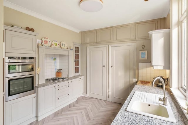 The fitted breakfast kitchen has granite work surfaces and integrated appliances.