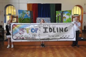 Banner design - Winning pupil Freya, middle, and Lily, runner-up, pictured left, at Starbeck Primary Academy with Chris Watt of Starbeck Residents Association who are urging drivers to turn their engines off if they are waiting at the local level crossings, to tackle air pollution.