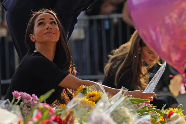 Meghan, Duchess of Sussex and Catherine, Princess of Wales view floral tributes left at Windsor Castle. (Photo by Kirsty O'Connor - WPA Pool/Getty Images)