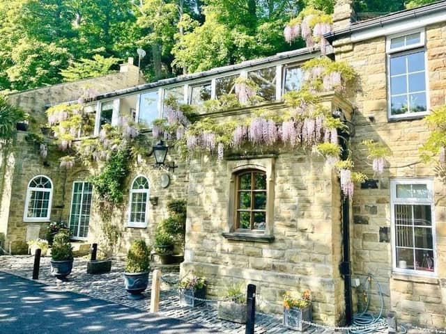 Wisteria drapes the exterior of the riverside property for sale in the market town of Knaresborough.